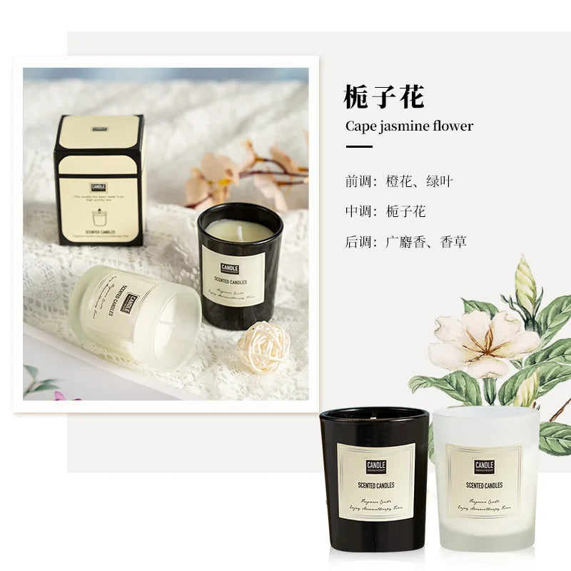 Two luxury scented candles in black and frosted white glass jars with a cream-coloured label on a lace background.