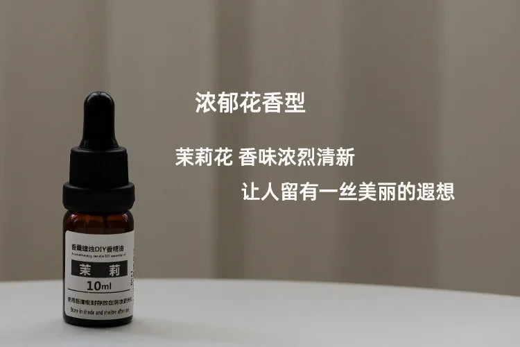 10ml amber glass bottle of jasmine essential oil with a black dropper cap, standing on a white surface.