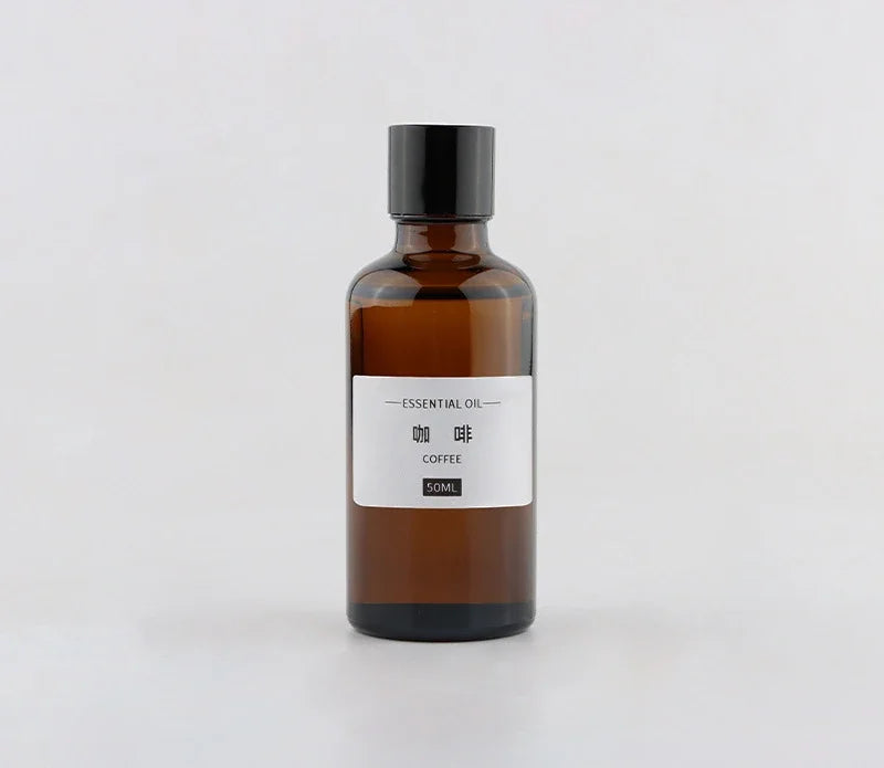 50ml amber glass essential oil bottle with a black screw cap and a minimalist label reading Coffee.