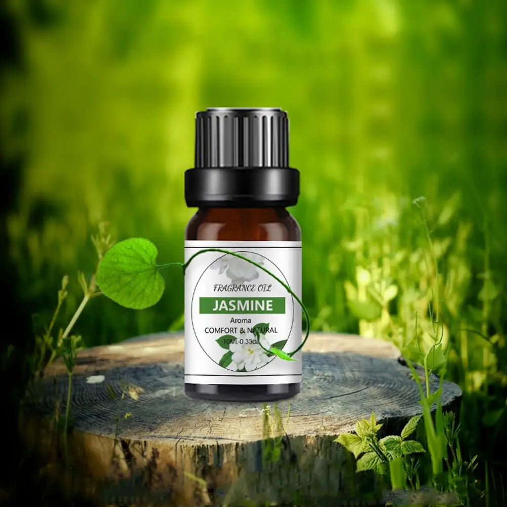 10ml bottle of Jasmine fragrance oil with a black cap, standing on a wooden stump against a blurred nature background.