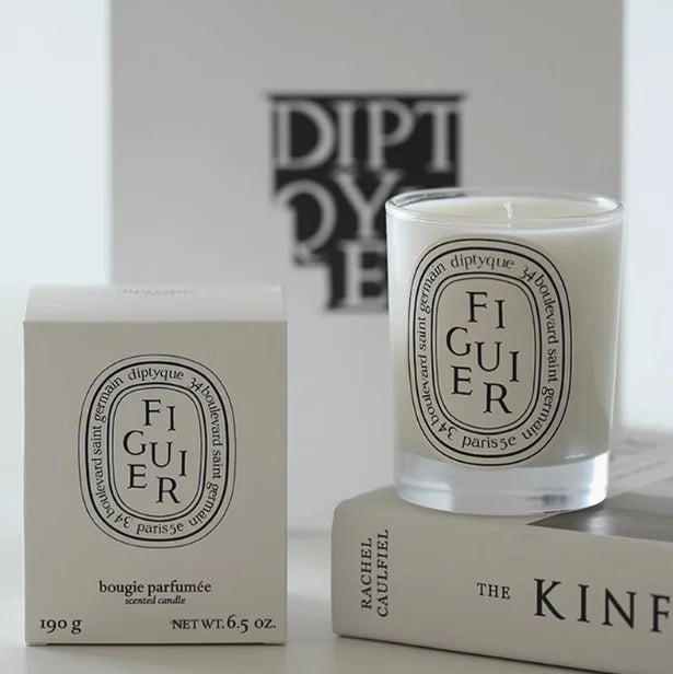 Fig scented candle in a glass jar with a white oval label, presented alongside its matching box packaging.