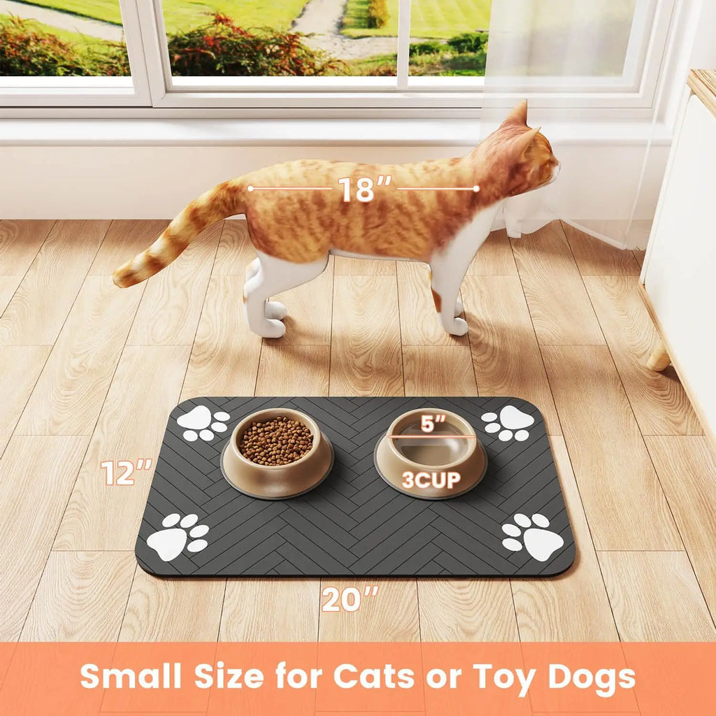 Grey rectangular pet feeding mat with a black herringbone pattern and white paw prints, holding two tan bowls.