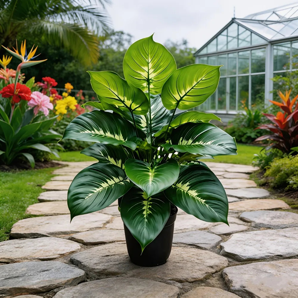 Large artificial plant in a black pot with broad, deep green leaves featuring pale yellow-white central variegation.
