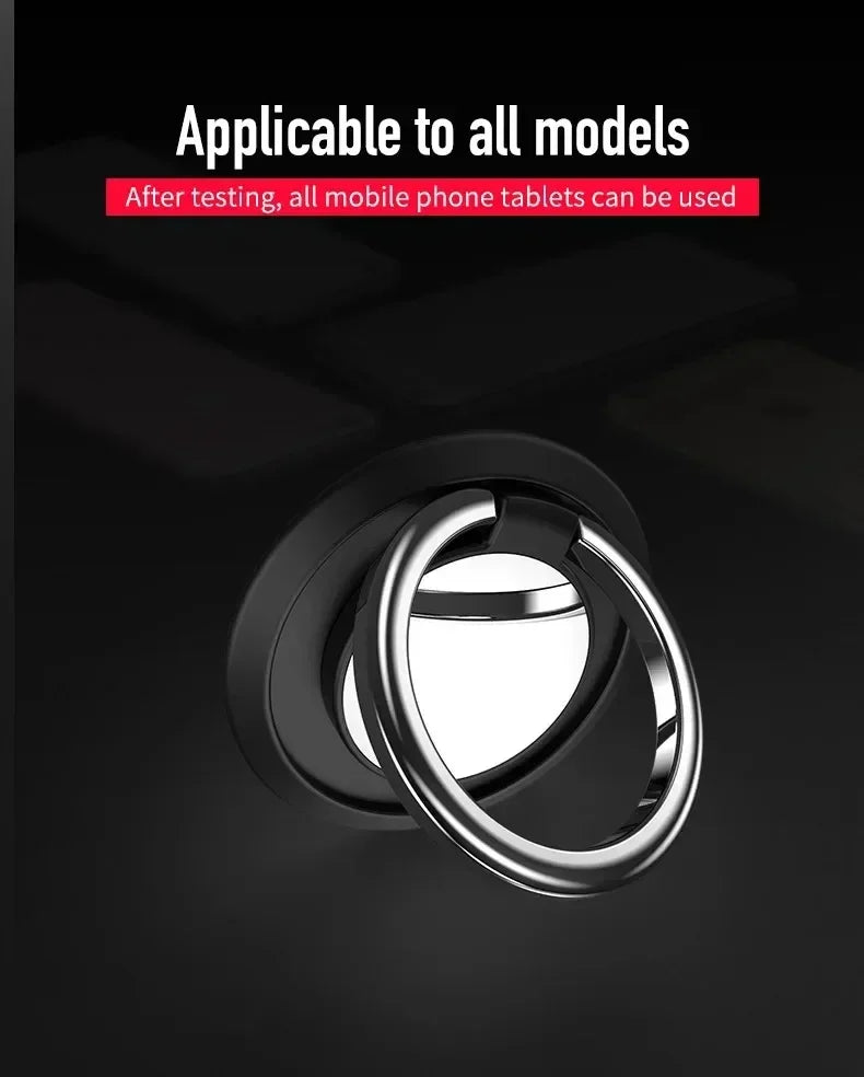 Black adhesive phone ring holder with a polished silver circular grip against a dark background.