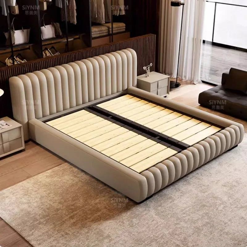 Modern cream-coloured bed frame with a stylish, vertically channel-tufted headboard and sturdy wooden slats.
