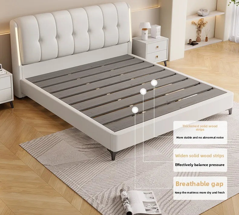 Minimalist cream white bed frame with a tufted headboard and sturdy grey wooden slats for support.