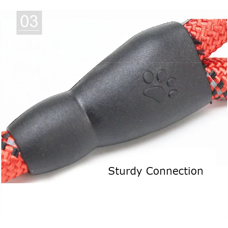 Close-up of a durable, reflective red and black woven dog leash featuring a sturdy black joint with a paw print icon.