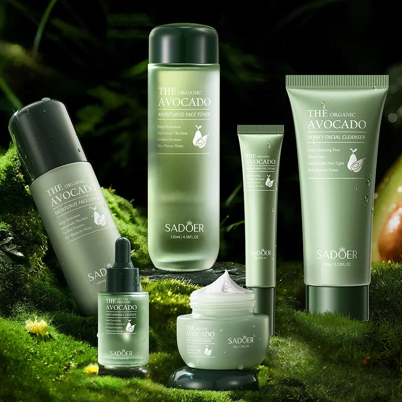 Set of six sage green avocado-themed skincare products, including cleansers, toners, and creams on a mossy background.