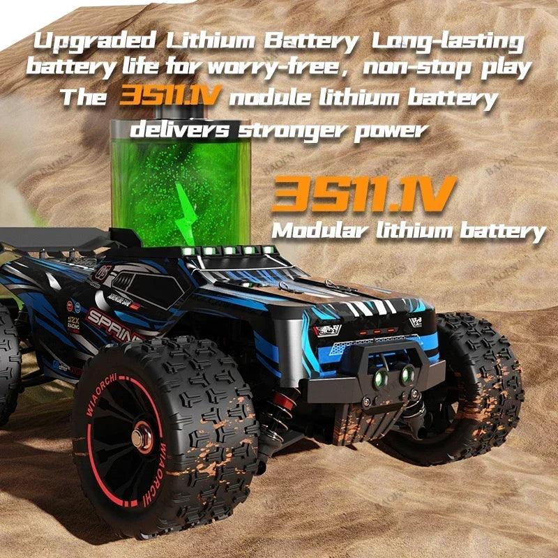 Black and blue 1:16 RC monster truck on sand, with large knobby tires, front headlights, and a modular battery graphic.