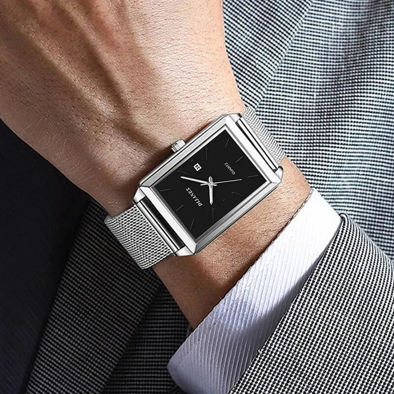Men’s square quartz watch with a black dial, date display, and polished silver mesh stainless steel strap.