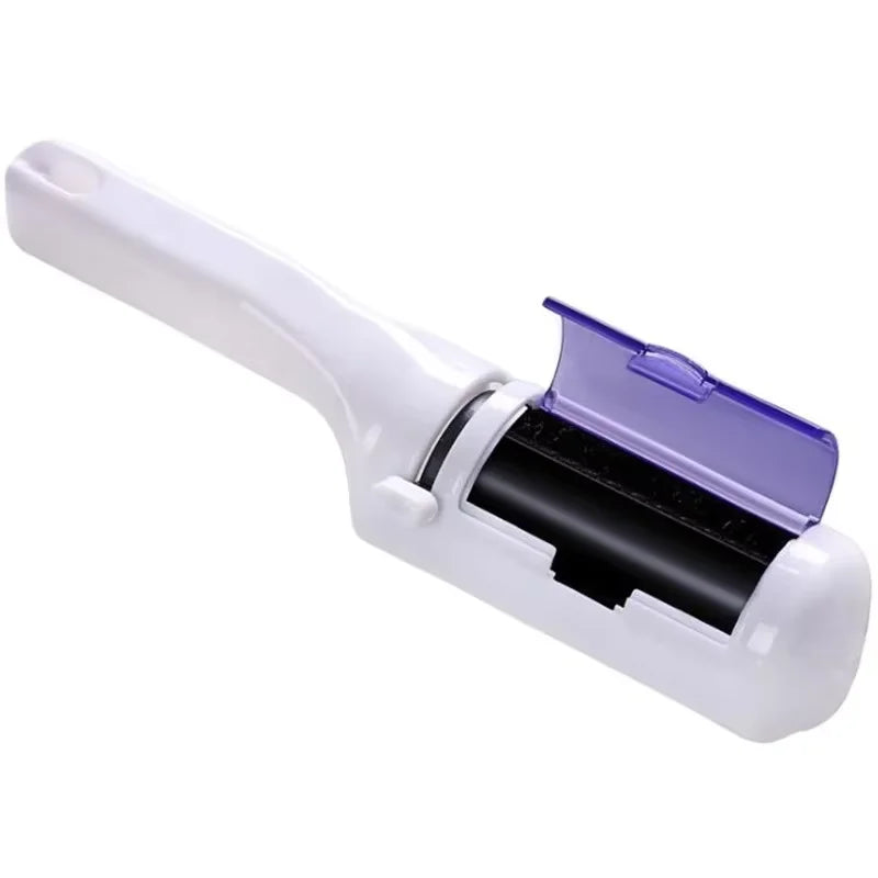 White lint remover tool with a handle and a purple flip-open compartment revealing a black cleaning roller.