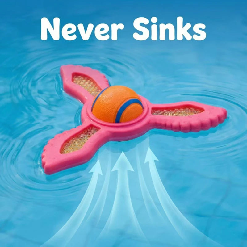 A pink, three-pronged floating dog fetch ring with a central orange ball, bobbing on blue pool water.