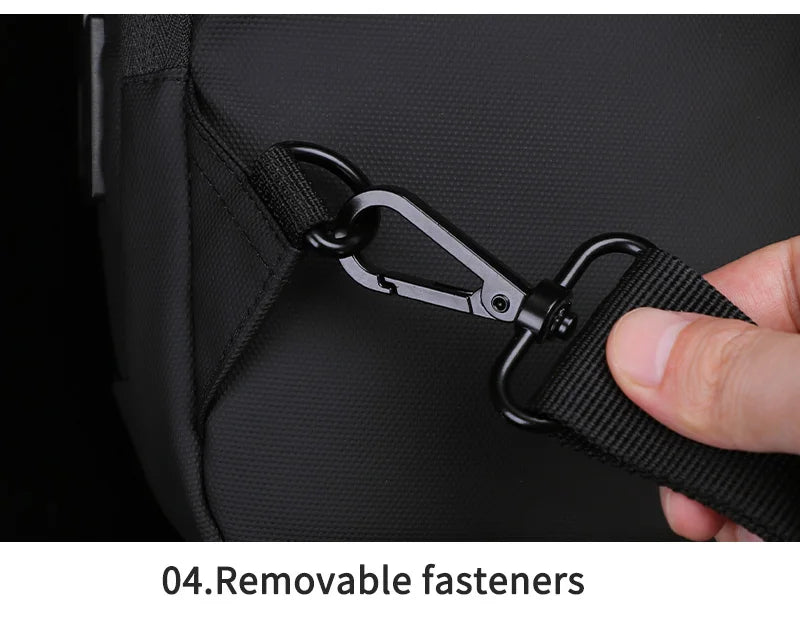 Close-up of a black waterproof crossbody bag featuring a durable, detachable metal clip on the adjustable strap.