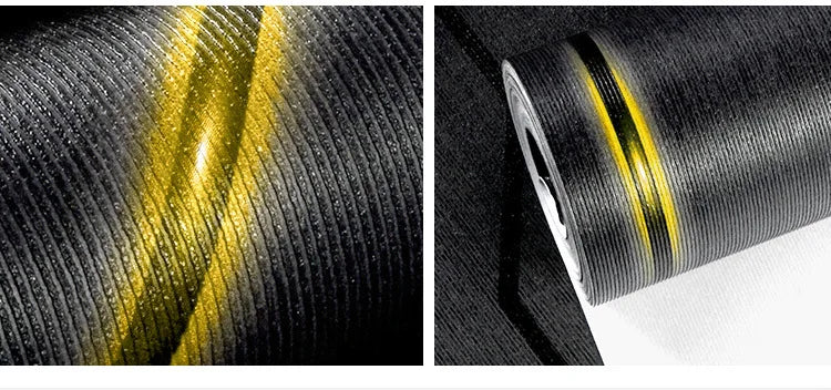 Modern black wallpaper with textured vertical stripes and a striking, reflective 3D metallic gold accent.