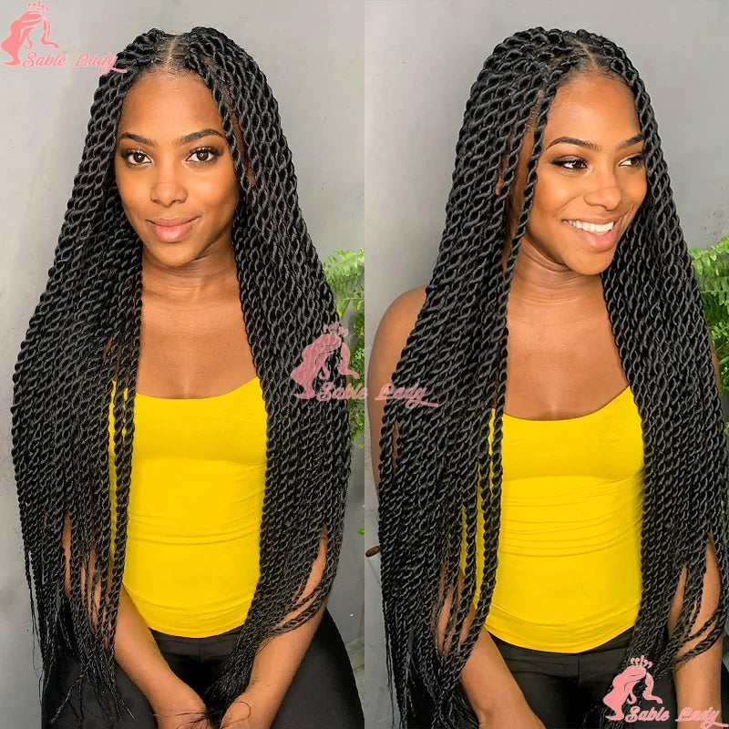 Long black Senegalese twist braid wig with a natural middle part worn by a smiling woman in a yellow top.