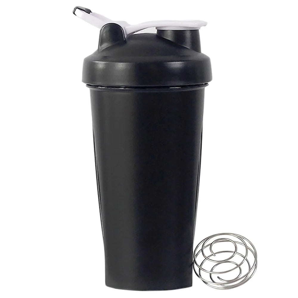 Black protein shaker bottle with a white flip-top lid and a stainless steel wire mixing ball on a white background.