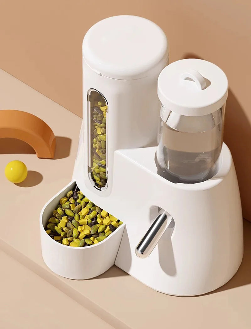 White pet feeder with a food hopper, water bottle, feeding bowl, and metal water dispenser nozzle on a beige surface.