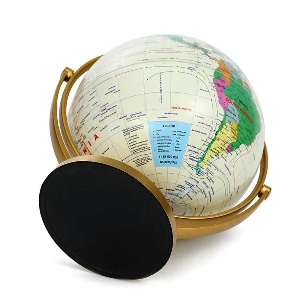 Desktop world globe with a cream-coloured map, mounted on a gold-tone metal stand with a round black base.