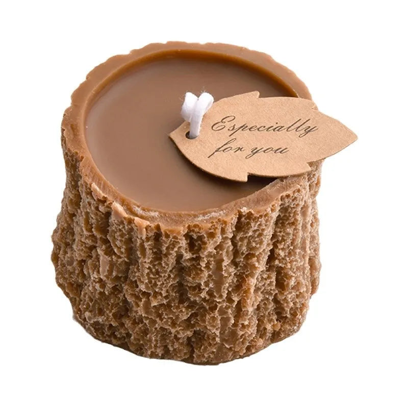 Brown tree stump-shaped wax candle with a white wick and a leaf-shaped tag reading "Especially for you."