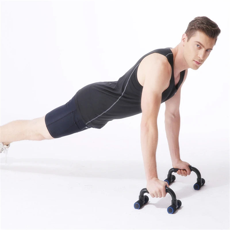 A man wearing black sportswear performing a plank using two black push-up bars with blue accents on a white background.