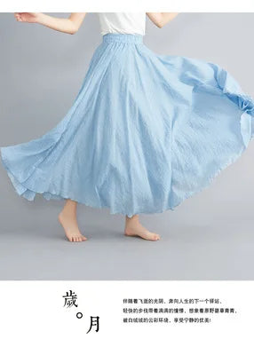 Flowing light blue maxi skirt with an elasticated waistband and a loose, flared silhouette in a soft, textured fabric.