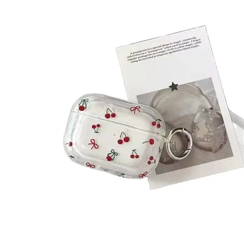 Clear TPU AirPod Pro case with red cherry print and silver keyring attachment.