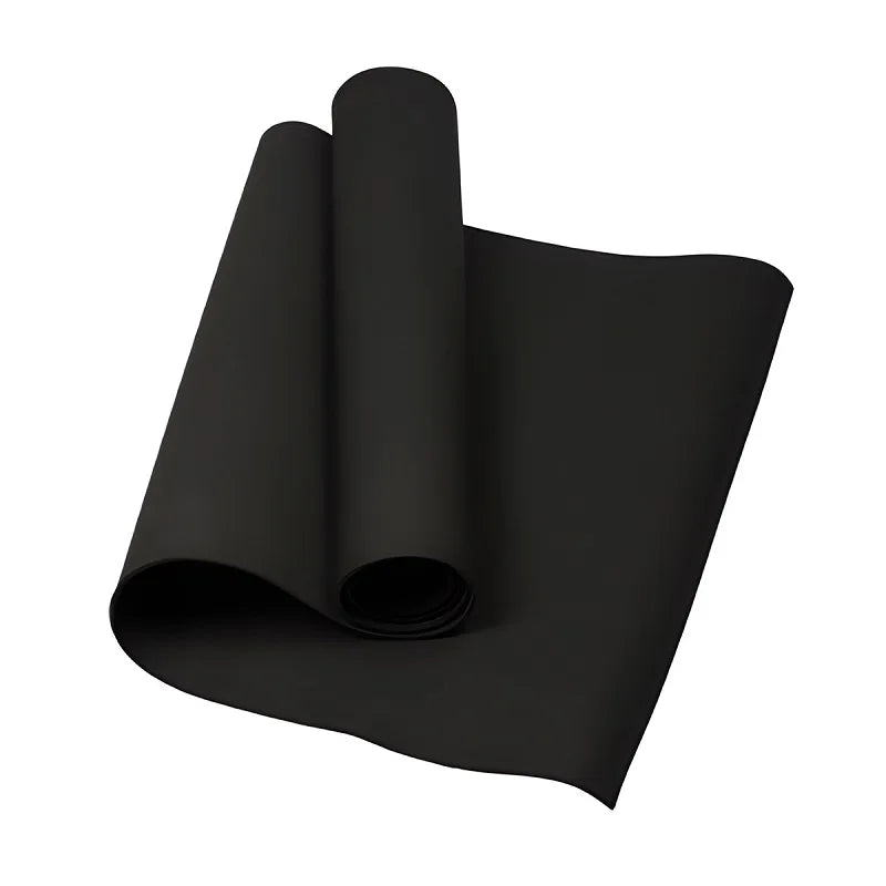 A solid black exercise or yoga mat partially unrolled against a plain white background.