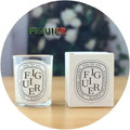 Fig scented candle in a clear glass jar with a matching white box featuring elegant oval typography.