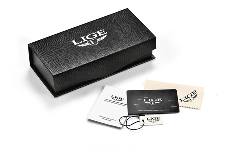 A black textured presentation box shown with an instruction manual, warranty card, and cleaning cloth on white background.