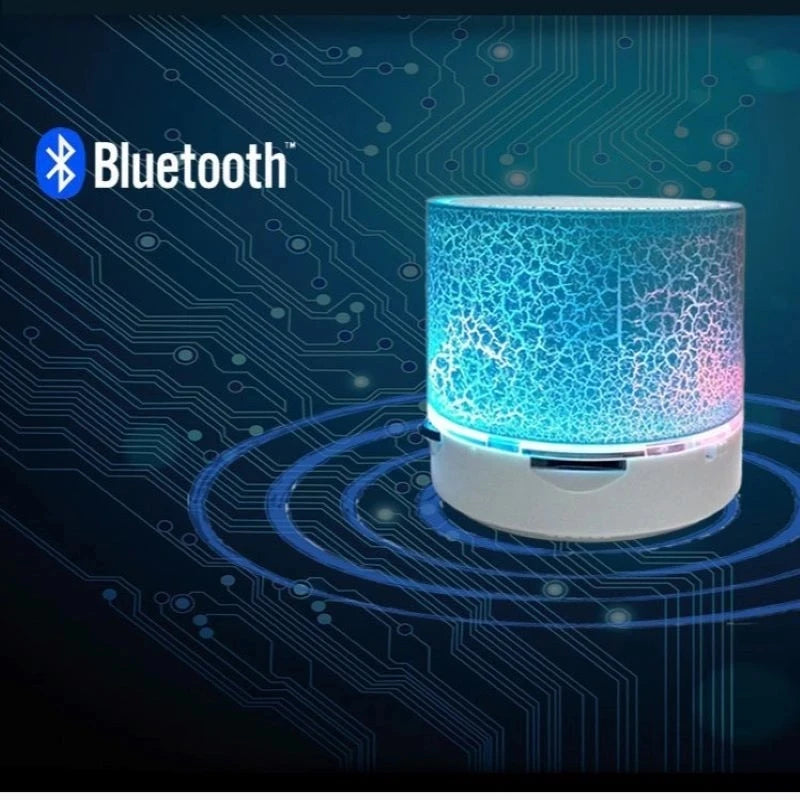 Portable mini Bluetooth speaker with a white base and a cylindrical, blue LED crackle-effect light display.