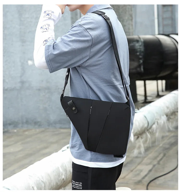 A person wearing a sleek, black minimalist waterproof chest bag across their shoulder with a secure strap design.