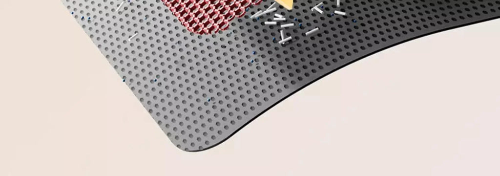Close-up of a black, heavy-duty waterproof cat litter mat with a honeycomb top layer to trap litter effectively.