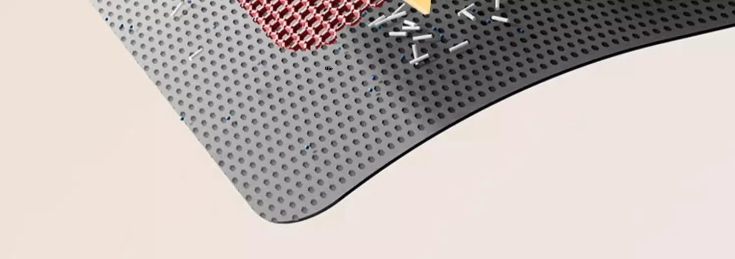 Close-up of a black, heavy-duty waterproof cat litter mat with a honeycomb top layer to trap litter effectively.