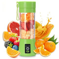 A lime green portable blender filled with fresh fruit, surrounded by oranges, strawberries, and other assorted fruit.