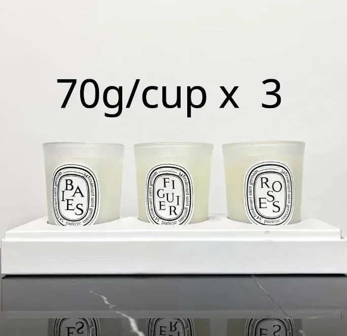 Set of three 70g scented candles in white frosted glass holders, presented on a white display tray.