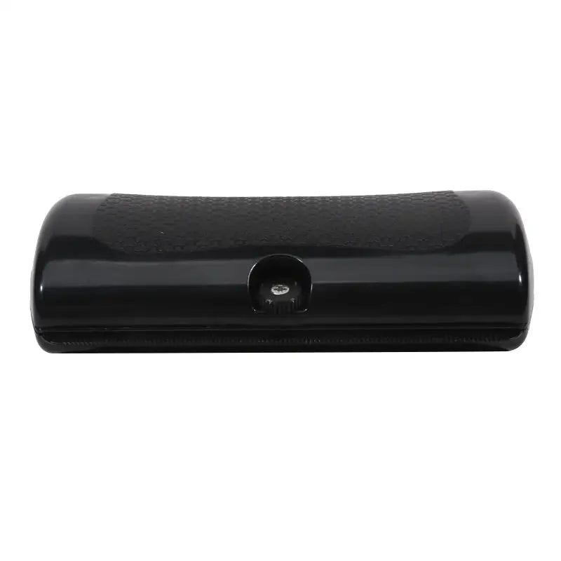 Glossy black, rectangular, handheld grooming tool with a textured grip panel and a central adjustment dial.