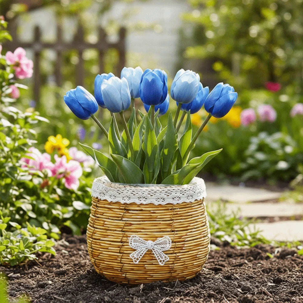 A rustic woven basket, trimmed with lace and a white bow, holds a vibrant bouquet of blue tulips in a garden setting.