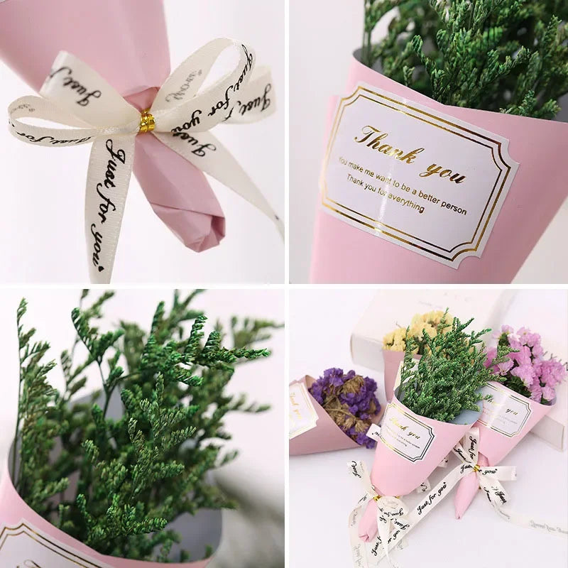 Small bouquets of colourful dried flowers wrapped in pink paper with 'Thank you' labels and ribbon bows.