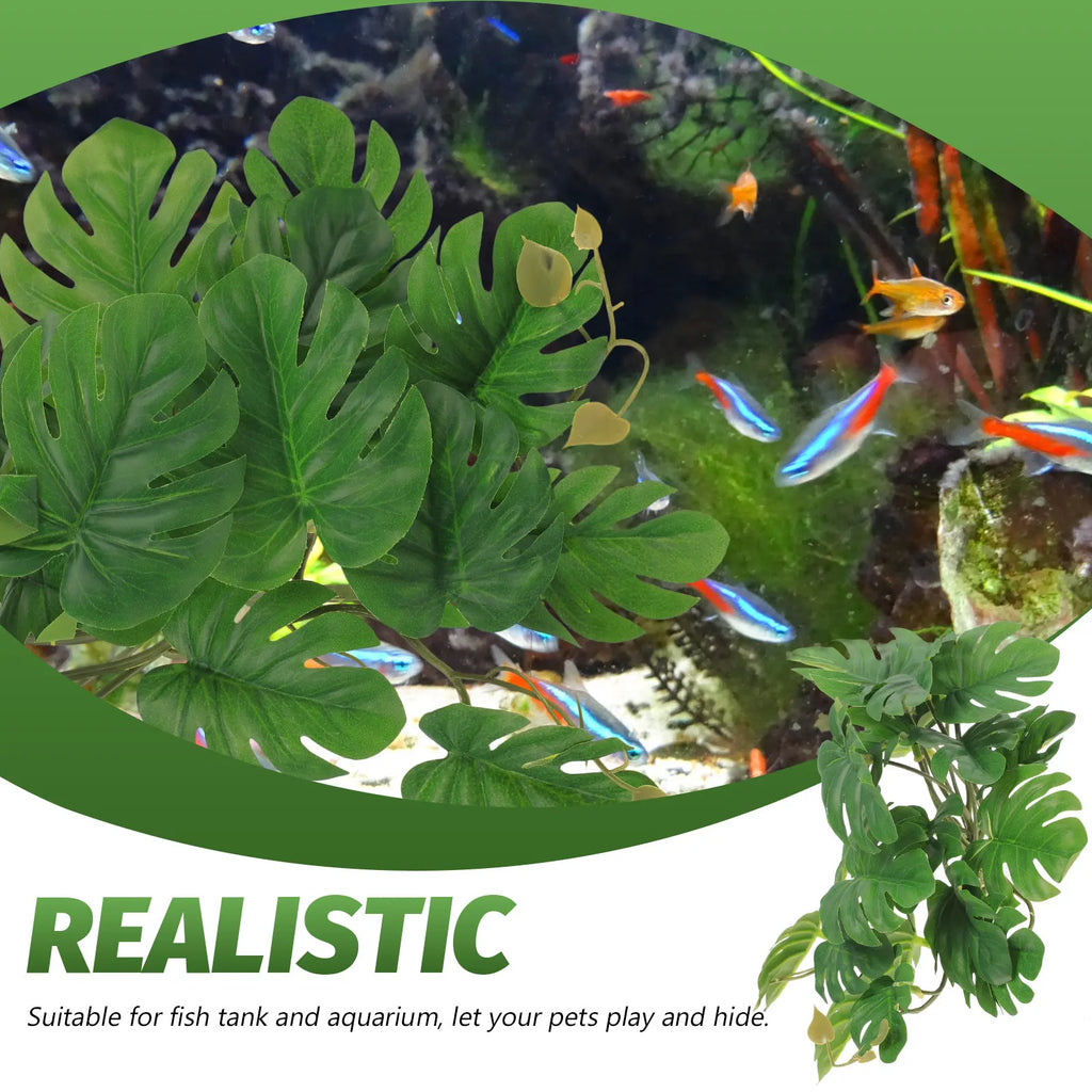 Artificial monstera plant with green, split leaves for reptile and fish tanks, shown in an aquarium with neon tetras.