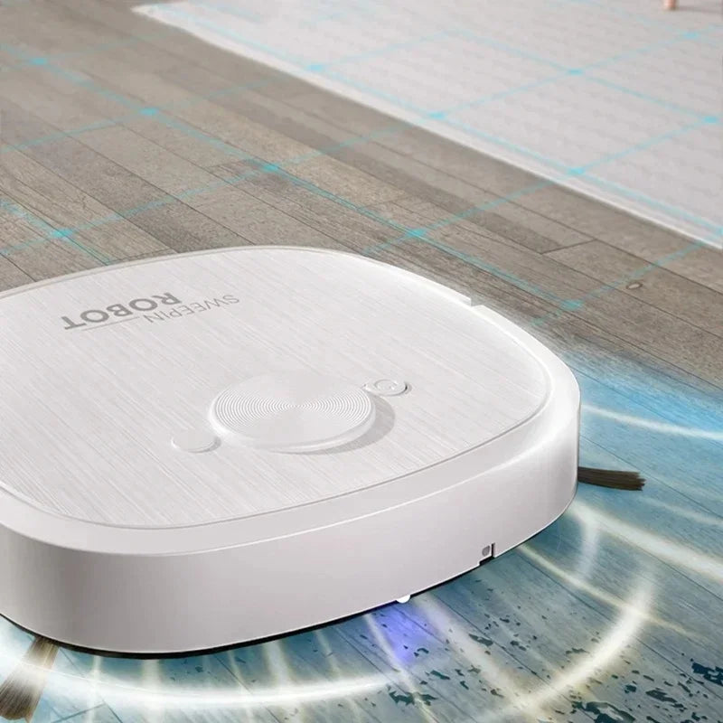 A white robot vacuum with a textured top surface cleans a hardwood floor.