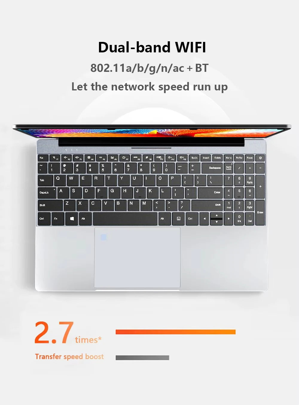 Top-down view of a silver, ultra-slim 15.6-inch laptop with a full-size keyboard and large trackpad.