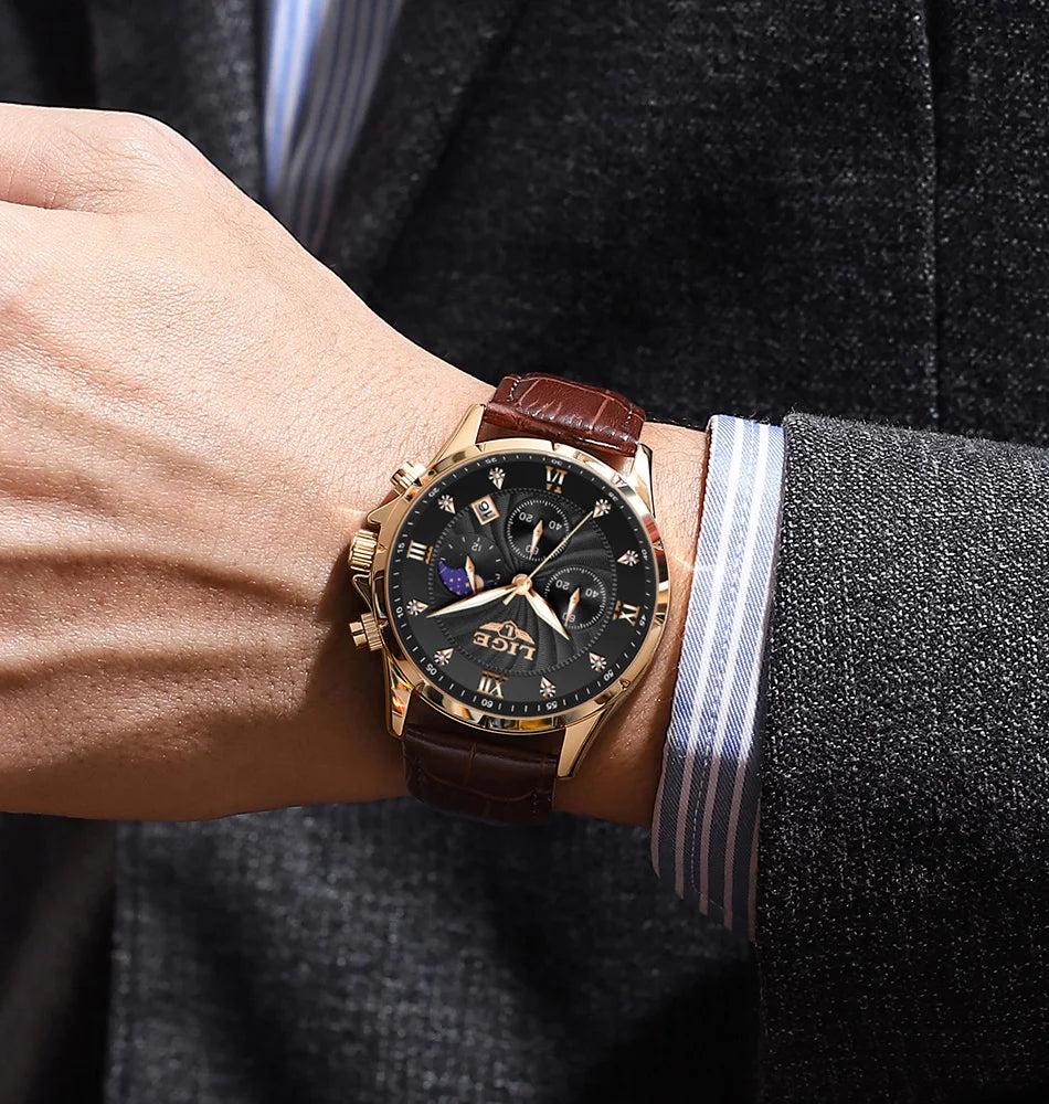 Men's chronograph watch with a black dial, gold-tone case, and brown leather strap worn on a wrist.