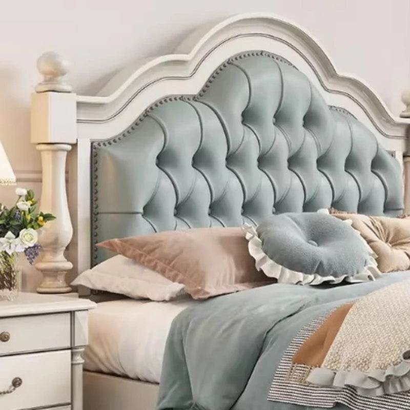 Elegant double bed frame with a pale blue tufted headboard, cream wooden frame, and decorative stud detailing.