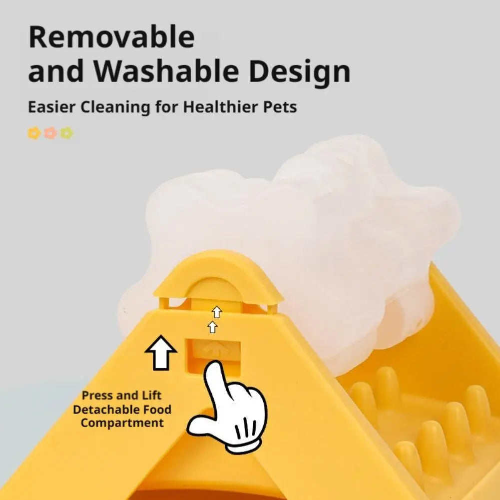 Yellow dog puzzle feeder toy with a detachable, washable white compartment. Features a clear lift-and-press mechanism.