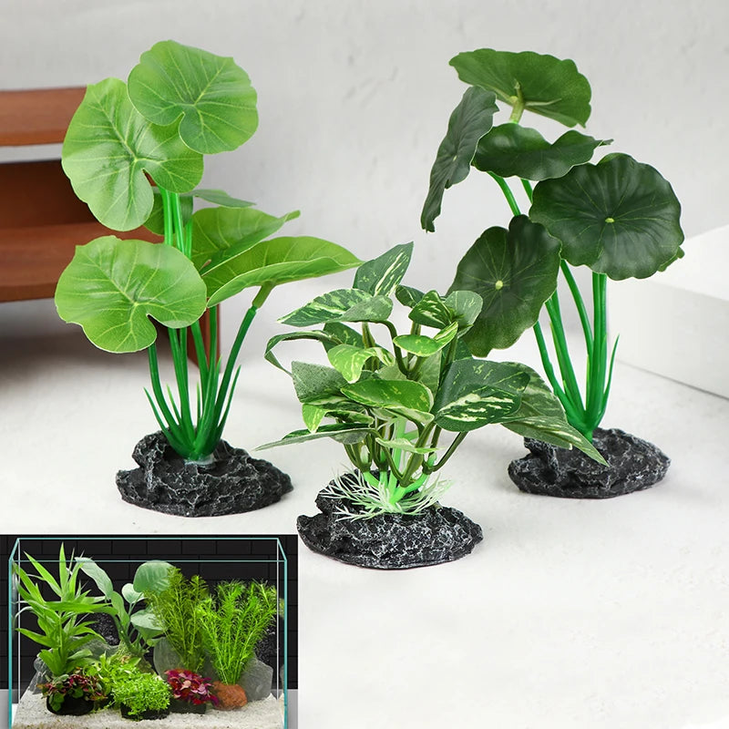 Three artificial aquarium plants with broad, realistic green leaves on sturdy, rocky bases, plus an inset tank view.
