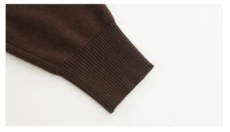 Close-up of a dark brown knitted sweater sleeve with a comfortable, ribbed elasticated cuff.