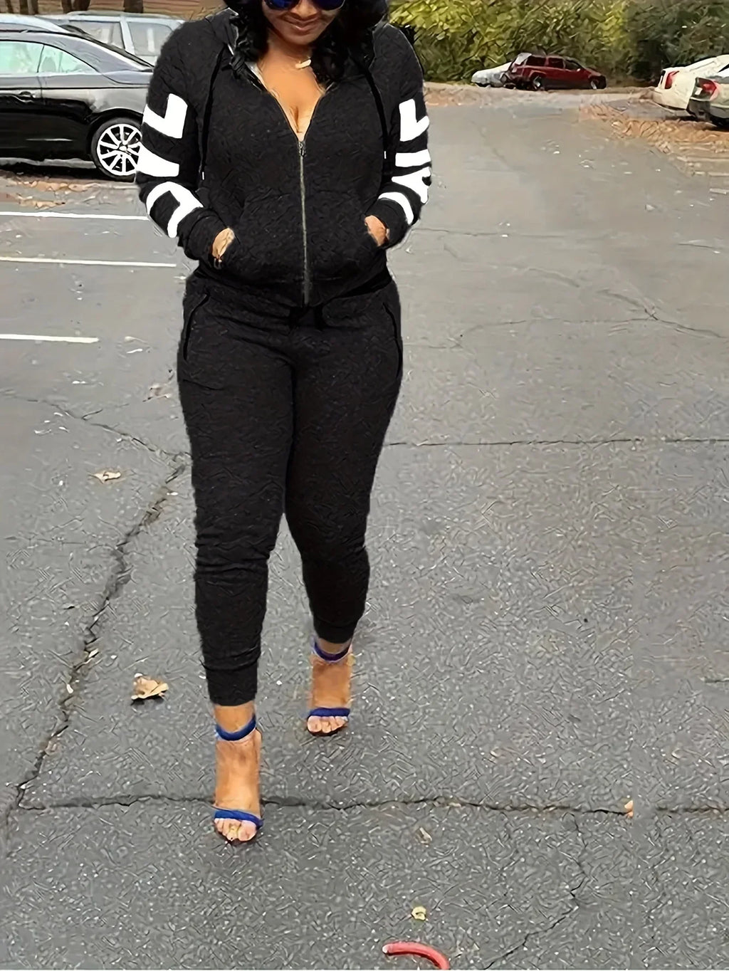 Black textured tracksuit featuring a zip-up hoodie with white sleeve stripes and matching slim-fit joggers.