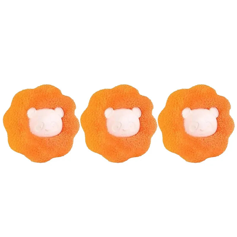 Three flower-shaped orange sponges with a central pale pink bear face motif.