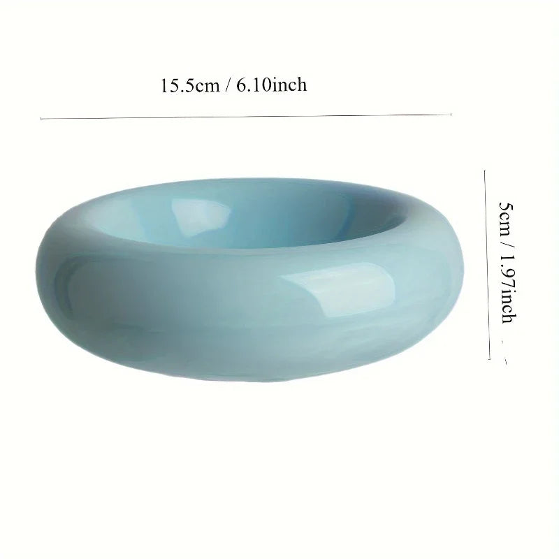 A smooth, light blue ceramic cat feeding bowl with a wide, rounded design. 15.5cm wide and 5cm high.
