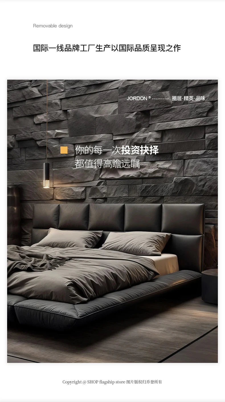 Modern charcoal grey leather king-size floating bed with a segmented, plush headboard against a dark stone wall.